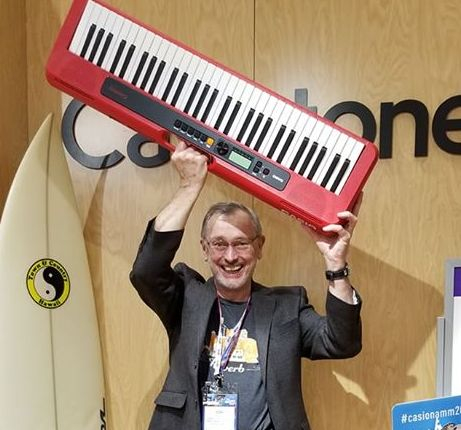 Tim Paul holding a keyboard at The NAMM Show