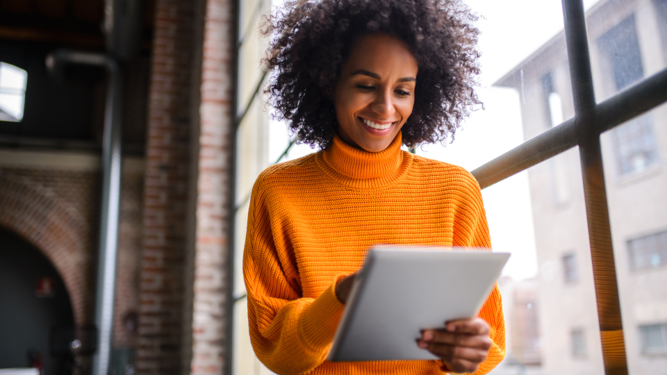 woman in office setting orange sweater