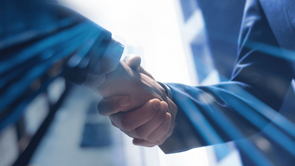 Businessmen making handshake with partner