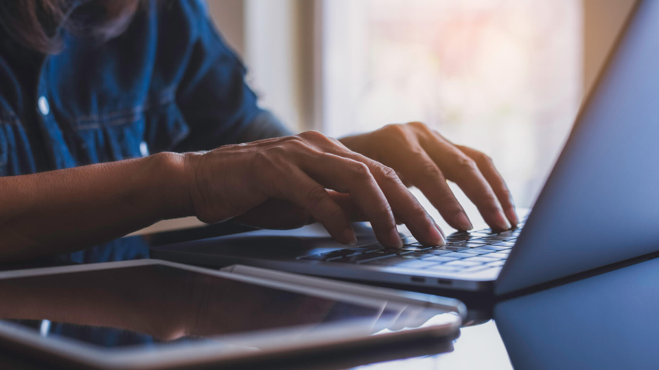 Woman typing on laptop