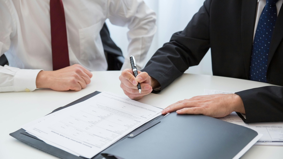 Businessperson signing document