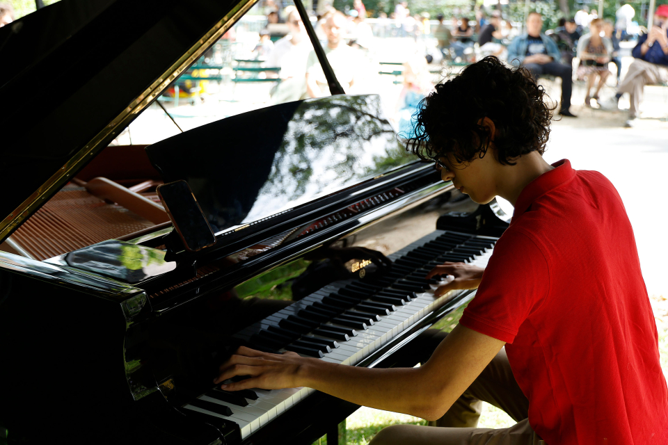 a boy plays the piano