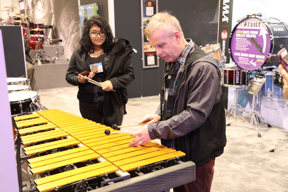 a man plays a xylophone at the namm show