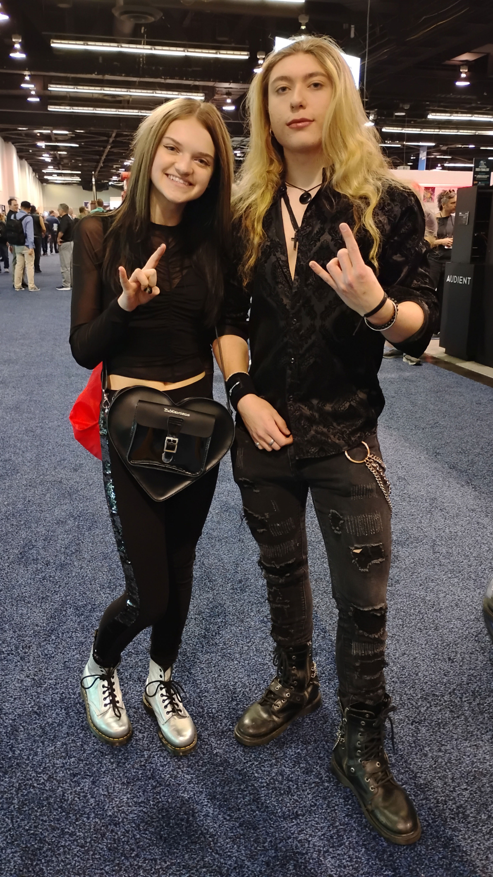 a pair dressed in black at the namm show