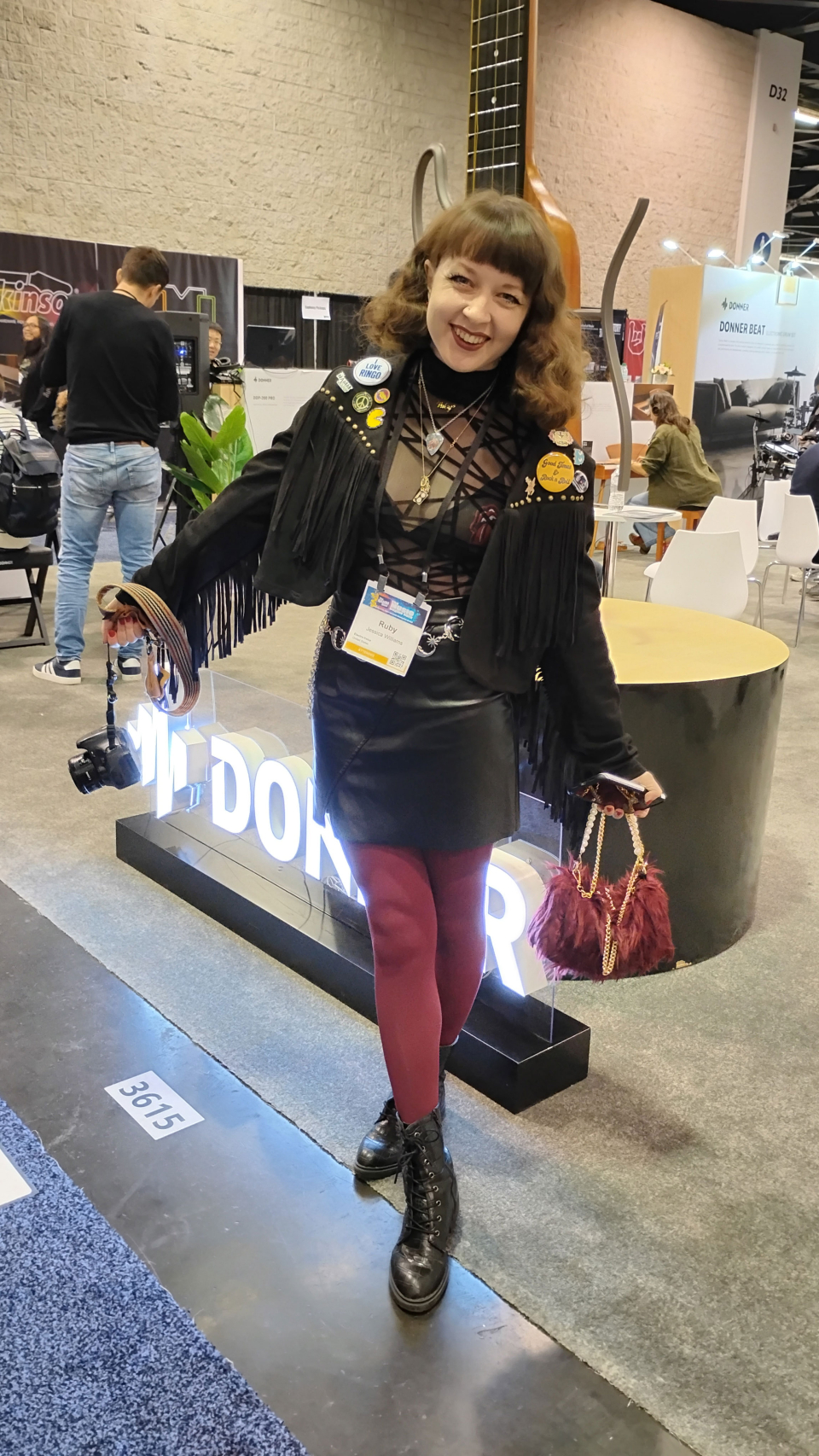 a woman at the namm show with leather skirt and red tights