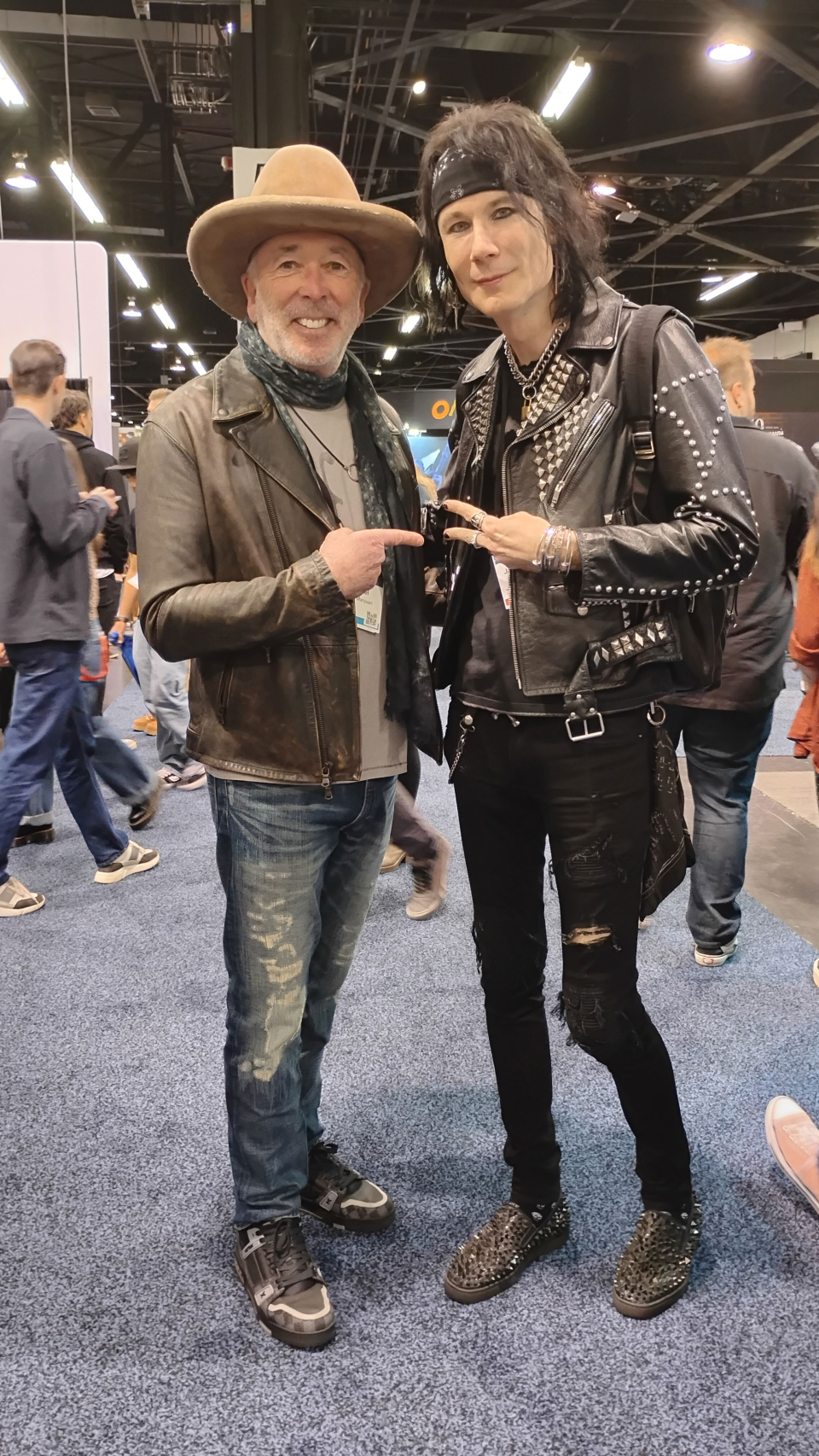 two men with a hat and black jacket at the namm show