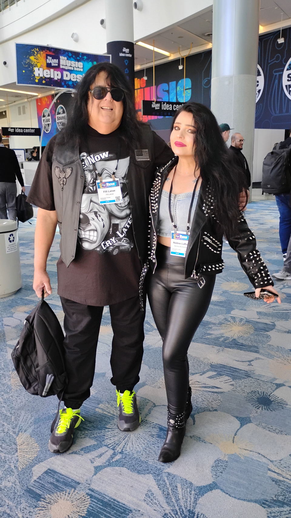 couple with black vest and jacket and leather pants at the namm show