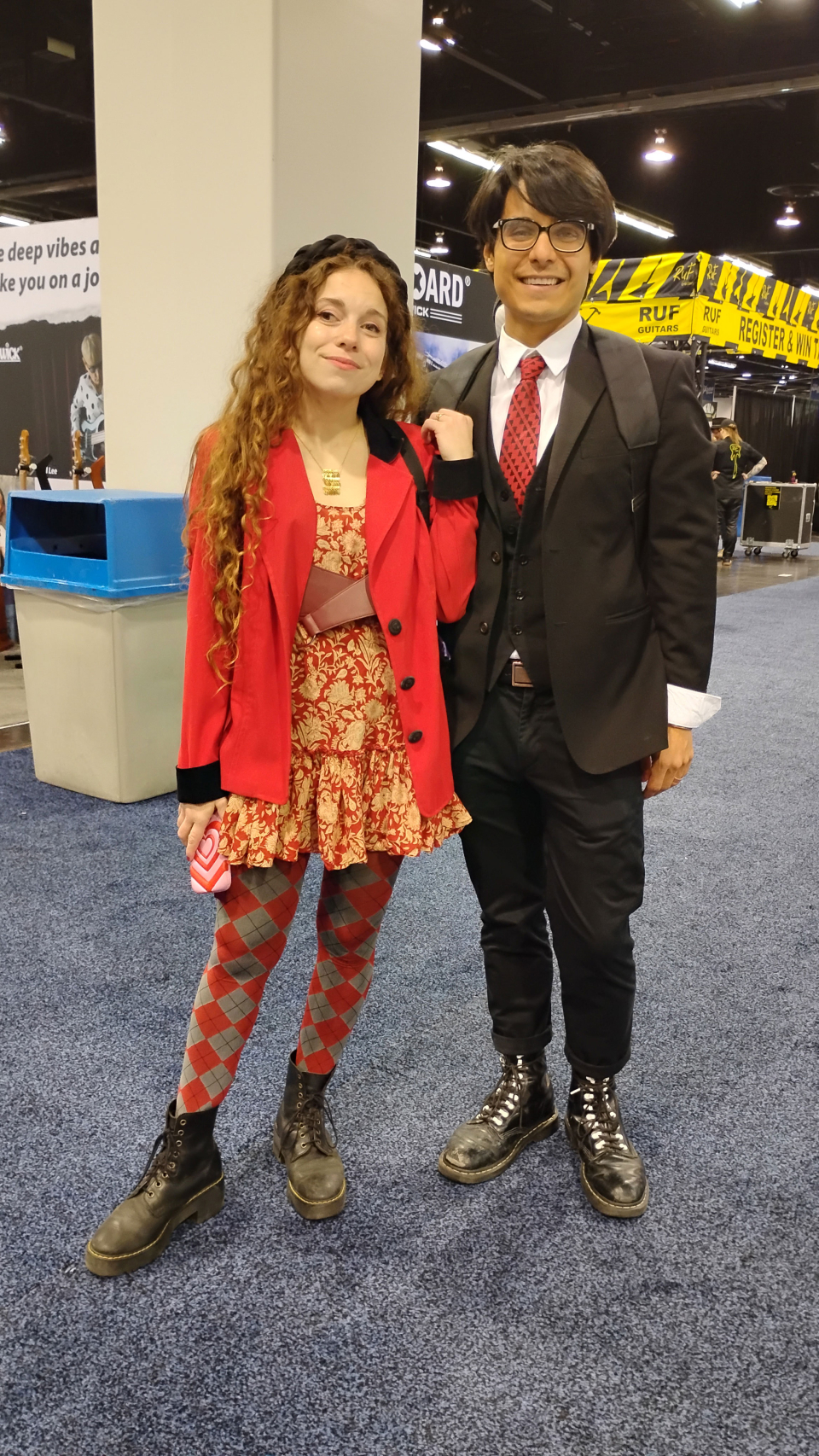 a man and woman pose in the namm show halls